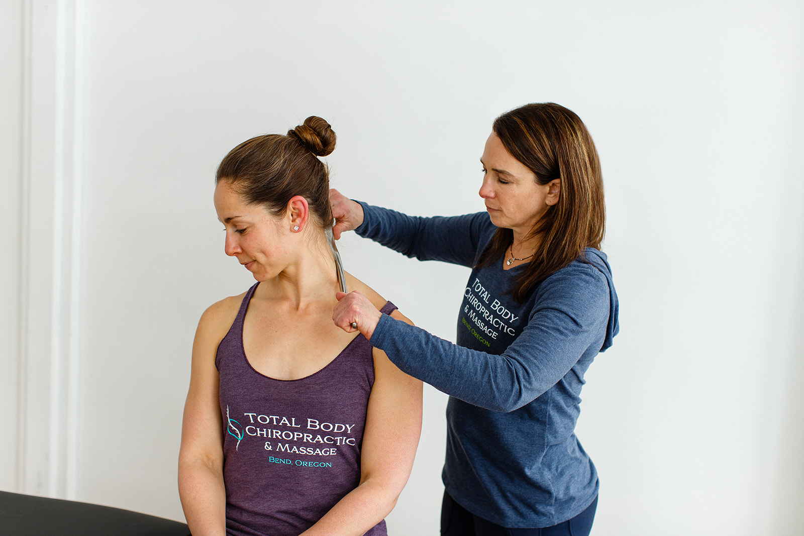 Bend chiropractor Bari Liebowitz using the graston technique on the neck of a patient for neck pain. 