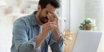 man-with-headache-at-computer