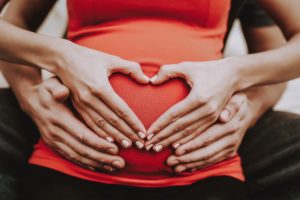pregnant-woman-making-heart-sign