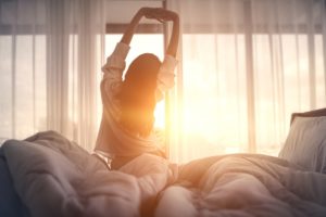 woman-waking-to-morning-sun