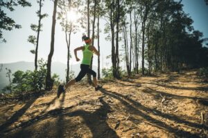 A lone female trail runner on a mountain trail in Bend, Oregon.