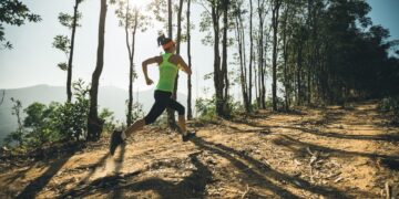 A lone female trail runner on a mountain trail in Bend, Oregon.