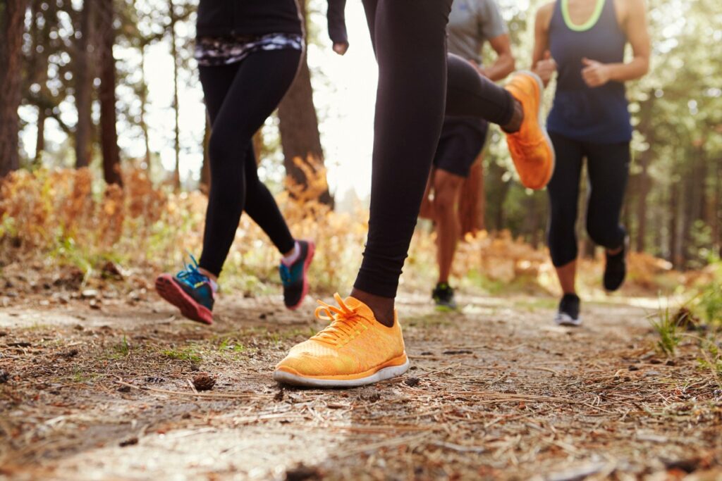 Close up of trail runners legs running on a trail in Bend, Oregon. 