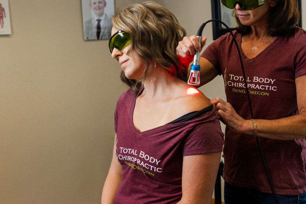 Laser therapy treatment being done on patient by chiropractor in Bend oregon.